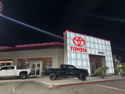 Hemet Toyota showroom and entrance outlined with Christmas lights at night
